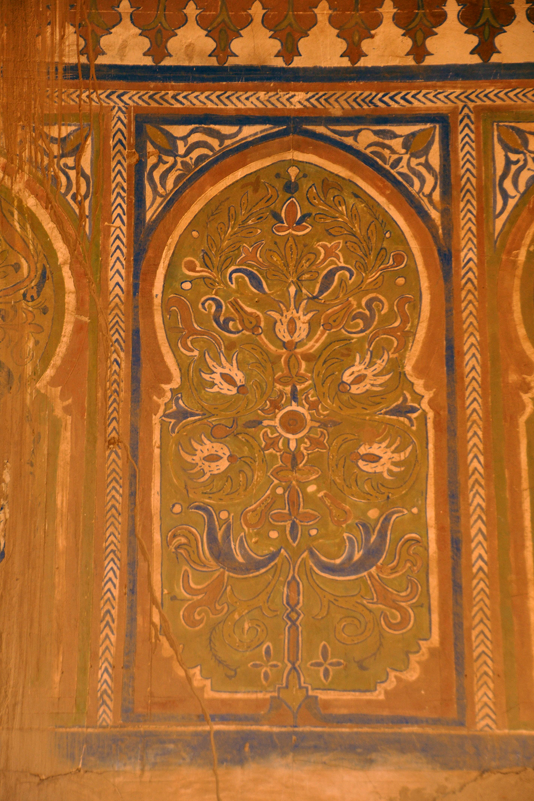 Photo of an intricately painted orange door in Morocco.